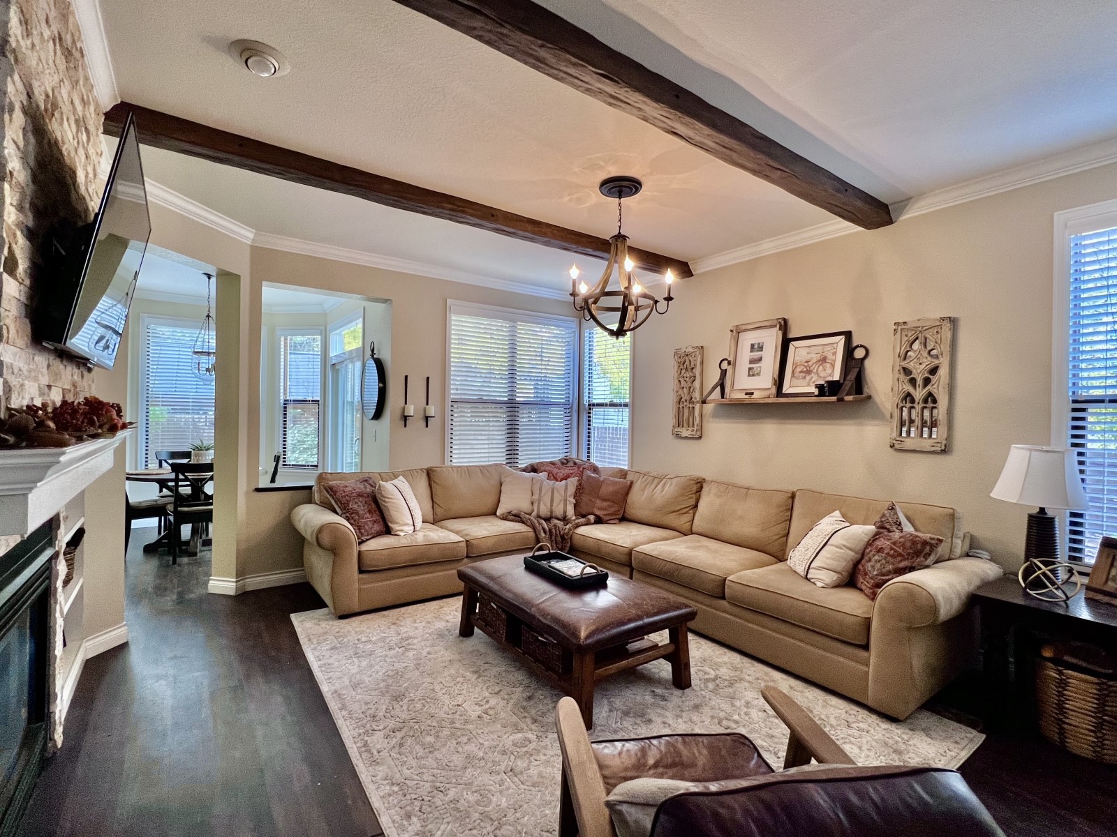 Living Room with hardwood floors and matching faux wood beams.