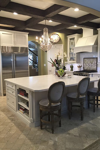 a farmhouse kitchen with coffered ceiling beams