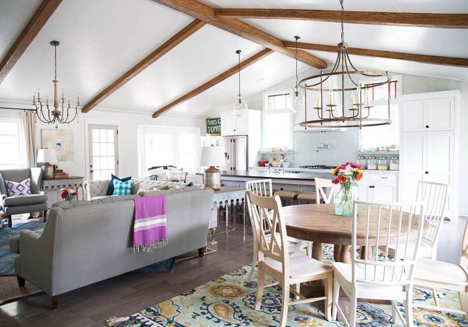 Faux beam spacing across an arched ceiling in an open-concept kitchen and living space.