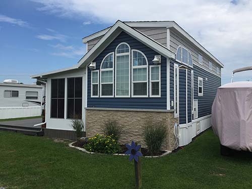 Faux siding used as mobile home skirting to add design and appeal and keep out rodents and pests 